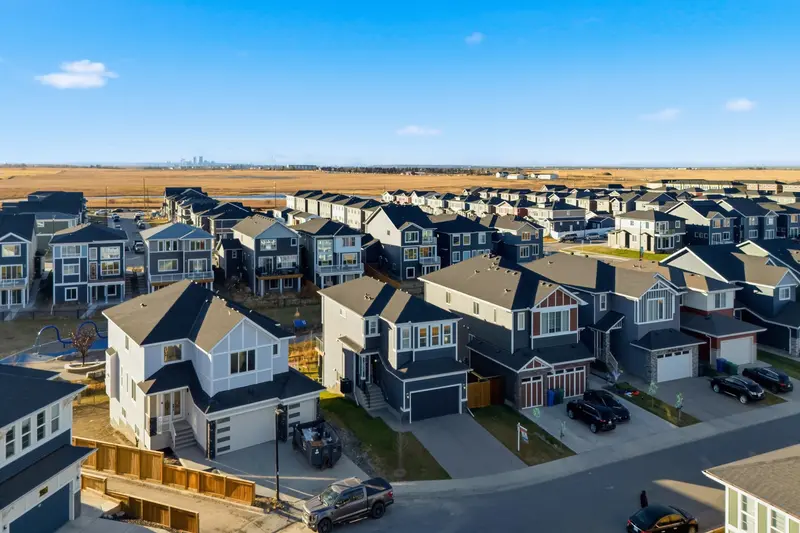Aerial view of Calgary suburban neighborhood with downtown skyline in distance